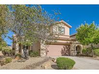 Two-story home with a two-car garage and desert landscaping in the front yard at 2728 Holmfault St, Henderson, NV 89044