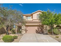Charming two-story home with a well-manicured front yard and attached two-car garage at 2728 Holmfault St, Henderson, NV 89044