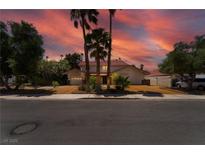 Charming home with mature trees, palm trees, and a long driveway leading to the attached two-car garage at 3341 Heavenly View Ct, Las Vegas, NV 89117