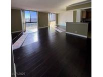 Bright living room with hardwood floors and big windows at 3930 University Center Dr # 702, Las Vegas, NV 89119