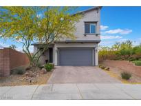 Inviting two-story home with a well-maintained lawn and a charming desert landscaped front yard at 5981 Smith Valley Rd, Las Vegas, NV 89148