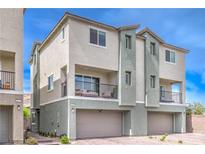 Townhome with a neutral color scheme, small balcony, and attached garage and desert landscaping at 6821 Prairie Pearl St, Las Vegas, NV 89148