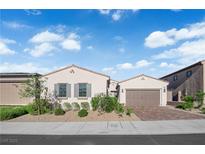 Charming single-story home with a two-car garage and landscaped front yard at 720 Webber Park St, Henderson, NV 89011