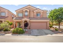 Two-story home with a well-manicured lawn, covered porch, and a two-car garage at 7641 Lani Dawn St, Las Vegas, NV 89149