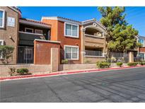 Multi-colored condo building with wrought iron fencing and lush green landscaping at 8101 W Flamingo Rd # 2006, Las Vegas, NV 89147