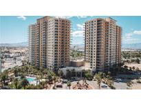 Stunning high-rise condo towers with lush landscaping, circular driveway, and a resort-style entrance at 8255 S Las Vegas Blvd # 1514, Las Vegas, NV 89123