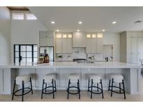 Modern kitchen with stainless steel appliances, ample counter space, and five barstool chairs at 9520 Sundial Dr, Las Vegas, NV 89134