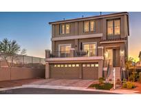 Charming two-story home featuring a balcony, three-car garage, and landscaped front yard at 10047 Alden Creek St, Las Vegas, NV 89141