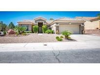 Charming single-story home with tile roof, desert landscaping, and attached two-car garage at 10301 Bent Brook Pl, Las Vegas, NV 89134