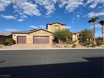 Beautiful two-story home featuring a three-car garage, desert landscaping, and a tile roof at 11088 Westcroft Way, Las Vegas, NV 89183