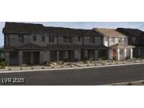 Row of townhouses in a suburban neighborhood featuring landscaped front yards at 136 Silver Run Ln, Las Vegas, NV 89138