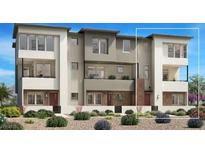 Modern townhome with a stylish exterior, balconies, and well-maintained landscaping at 1543 Stone Perch St, Las Vegas, NV 89138