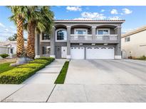 Charming two-story home with a three car garage, lush landscaping, and inviting curb appeal at 1680 Sweet Pea Ave, Las Vegas, NV 89183