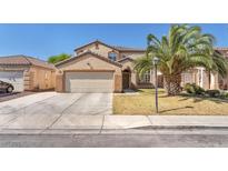 Charming two-story home with a well-manicured lawn and a spacious two-car garage at 2104 Spanish Town Ave, North Las Vegas, NV 89031