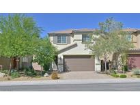 Charming two-story home featuring a tile roof, neutral stucco, a two-car garage, and desert landscaping at 2228 Sky Island Dr, Henderson, NV 89002