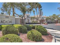 Beautiful community entrance with lush landscaping, decorative boulders, and a gated entry for added security and privacy at 2325 Windmill Pkwy # 312, Henderson, NV 89074