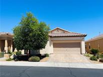 Charming single-story home featuring a well-manicured lawn, desert landscaping, and a two-car garage at 248 Windmill Croft Dr, Las Vegas, NV 89148