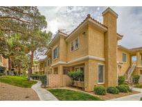 Charming two-story condo featuring a stucco exterior, red tile roof, and well-maintained landscaping at 251 S Green Valley Pkwy # 1311, Henderson, NV 89012