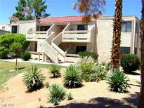 Two-story stucco condo with red tile roof and desert landscaping on a sunny day at 3720 Desert Marina Dr # 33, Laughlin, NV 89029