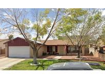 Charming single-story home featuring a well-manicured front lawn and a traditional two-car garage at 5921 San Fernando Dr, Las Vegas, NV 89108