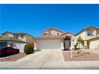 Charming single-story home with well-maintained landscaping and a spacious two-car garage, with a clear blue sky at 6002 Stone Hollow Ave, Las Vegas, NV 89156