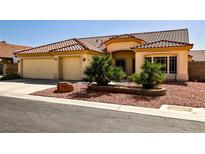 Charming home with a tile roof, three-car garage and desert landscaping, providing a welcoming curb appeal at 6016 Bungalow Bay St, Las Vegas, NV 89130