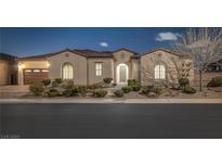 Charming single-story home featuring a tile roof, arched windows, manicured landscaping, and a two-car garage at 6333 Orto Vaso Ave, Las Vegas, NV 89131