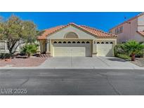 Charming single-story home with a well-maintained yard and a three-car garage at 7460 Desert Flame Ct, Las Vegas, NV 89149