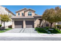 Charming two-story home featuring a tile roof, well-maintained landscaping, and a spacious two-car garage at 852 Colina Alta Pl, Las Vegas, NV 89138