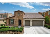 Charming single-Gathering home with a stone facade, two-car garage, and well-maintained landscaping at 1005 Old Creek Way, North Las Vegas, NV 89084