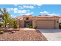 Charming single-story home boasts a desert landscape, neutral colors and tile roof at 10901 Fort Valley Ave, Las Vegas, NV 89134