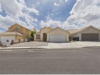 Charming single-story home featuring a low-maintenance front yard and a two-car garage, providing a welcoming curb appeal at 1305 Pagentry Dr, North Las Vegas, NV 89031