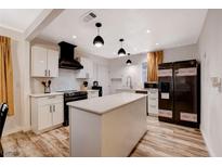 Bright kitchen featuring white cabinets, a large island, modern appliances, and stylish pendant lighting at 1414 S 13Th St, Las Vegas, NV 89104