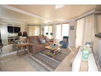 Inviting living room featuring tile floors, a comfortable couch, and plenty of natural light at 270 E Flamingo Rd # 223, Las Vegas, NV 89169