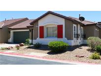 Charming single-story home with red shutters, well-maintained landscaping, and a two-car garage at 2840 China Cove St, Laughlin, NV 89029