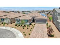 Beautiful single story home featuring desert landscaping, brick paver driveway, and a two car garage at 2910 Monate Ct, Henderson, NV 89044