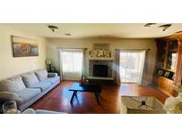 Comfortable living room with large windows, fireplace, and neutral-colored furniture at 3301 W Colton Ave, North Las Vegas, NV 89032