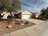 Charming single-story home with desert landscaping, two car garage and neutral color scheme at 3508 Kittiwake Rd, North Las Vegas, NV 89084