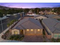Charming single-Gathering home featuring a three-car garage and landscaped front yard with mature trees and palm trees at 3706 Etendre Ct, Las Vegas, NV 89121