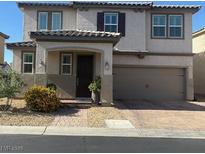Charming two-story home featuring a two-car garage, neutral stucco, and a tile roof, complemented by front yard landscaping at 3854 Stadium Ave, Las Vegas, NV 89120