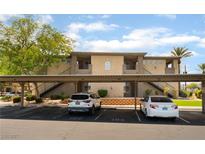 Exterior view of building with covered parking and well-maintained landscaping at 4400 S Jones Blvd # 2033, Las Vegas, NV 89103