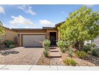Charming single-story home with well-manicured landscaping and a brick-paved driveway at 485 Pebble Run Ave, Henderson, NV 89011