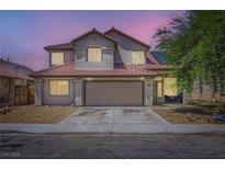 Charming two-story home with a red tile roof, well-manicured lawn, and attached two-car garage at 5502 Cinnamon Ave, Las Vegas, NV 89122