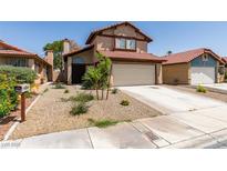 Charming two-story home with a red tile roof and a well-maintained front yard in a residential neighborhood at 6436 Deadwood Rd, Las Vegas, NV 89108