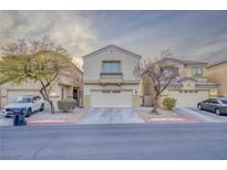 Inviting two-story home featuring a well-kept front yard, neutral tones, and an attached two-car garage at 6525 Raven Hall St, North Las Vegas, NV 89084