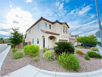 Charming two-story home with neutral stucco, tiled roof, landscaped front yard, and a two-car garage at 7083 Seat Wall Rd, Las Vegas, NV 89148