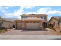 Beautiful two-story home featuring a three car garage and desert landscaping at 7107 Calvert Cliffs St, North Las Vegas, NV 89084