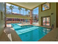 Stunning indoor pool area with large windows and lounge chairs at 75 E Agate Ave # 206, Las Vegas, NV 89123