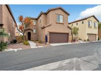 Inviting two-story home with a brown garage door, desert landscaping and neutral-toned stucco facade at 8152 Satin Carnation Ln, Las Vegas, NV 89166