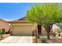 Charming single-story home featuring a two-car garage, desert landscaping, and stone accents at 9137 Big Plantation Ave, Las Vegas, NV 89143